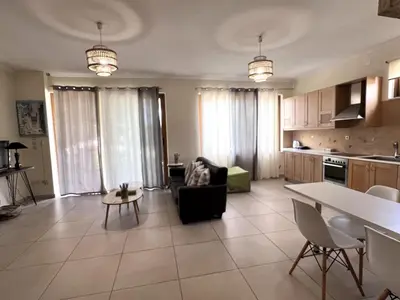 a kitchen and living room with a couch and a table at Chania Green House 1 in SFakianalíon