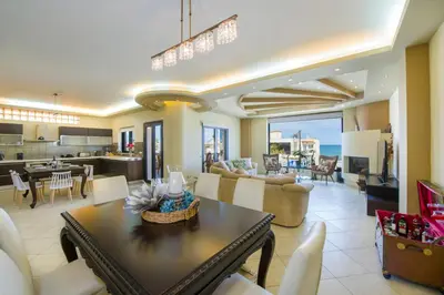 a living room with a dining room and a kitchen at Manolia Dream Apartment 3-bedrooms 30m to the beach in Agia Marina Nea Kydonias
