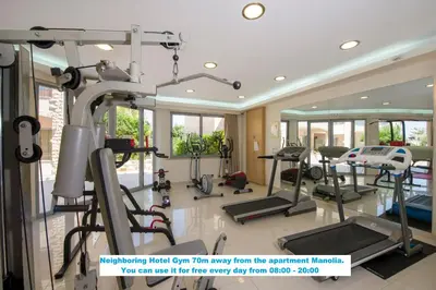 a gym with treadmills and ellipticals in a room at Manolia Dream Apartment 3-bedrooms 30m to the beach in Agia Marina Nea Kydonias