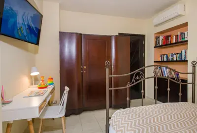a bedroom with a bed and a desk and a bed and a desk and chair at Manolia Dream Apartment 3-bedrooms 30m to the beach in Agia Marina Nea Kydonias