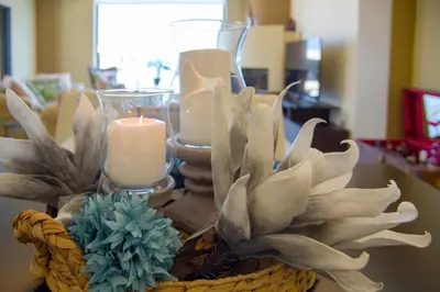 a basket with candles and flowers on a table at Manolia Dream Apartment 3-bedrooms 30m to the beach in Agia Marina Nea Kydonias