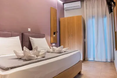 a bedroom with a bed with white flowers on it at Semeli Studios in Chania Town
