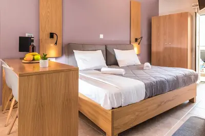 a bedroom with a large bed and a desk at Semeli Studios in Chania Town