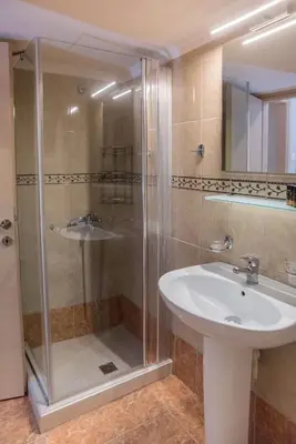 a bathroom with a shower and a sink at Semeli Studios in Chania Town