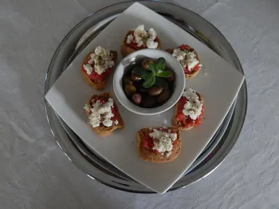 a plate of appetizers with a bowl of olives at Posidonio Hotel in Chania Town