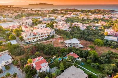 an aerial view of a city with houses and the ocean at Chania Green House 2 in Aghii Apostoli