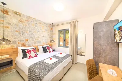 a bedroom with a bed and a table and a tv at Villa Vardis Heated Pool in Vryses