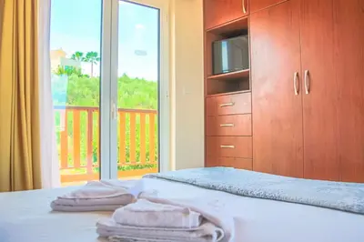 a bedroom with a bed with two towels on it at Villa Panagiotis Chania in Daratso