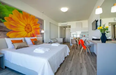 a bedroom with a white bed with a large flower on it at Incognito Creta Luxury Suites and More in Kolymvari