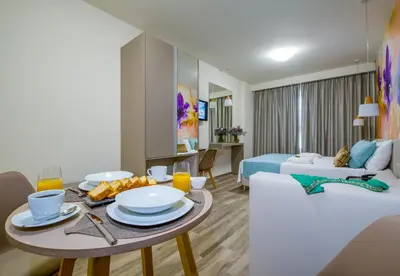 a living room with a table and a couch at Incognito Creta Luxury Suites and More in Kolymvari