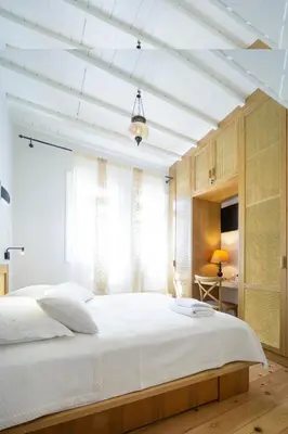 a bedroom with a large white bed and a window at Kallinikou Residence - private parking on demand - in Chania Town