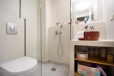 a bathroom with a shower and a toilet and a sink at Kallinikou Residence - private parking on demand - in Chania Town