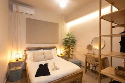 a bedroom with a bed with a black dress on it at Palm Luxury Studios in Chania Town