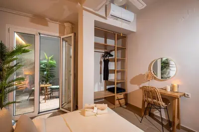 a bedroom with a bed and a desk and a mirror at Palm Luxury Studios in Chania Town
