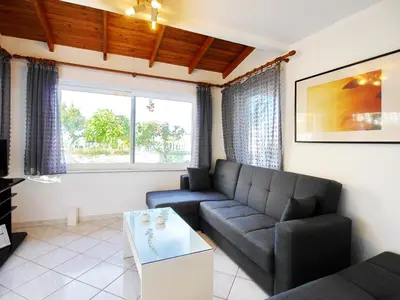 a living room with a couch and a table at Rouladina Apartments in Stalos