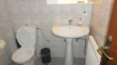a bathroom with a white toilet and a sink at Summer Holidays Studio in Chania Town