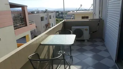 a balcony with a table and chairs on a balcony at Summer Holidays Studio in Chania Town