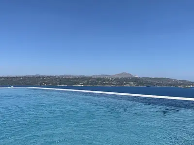a swimming pool next to a body of water at Villa Nikos Megala Chorafia Crete in Áptera