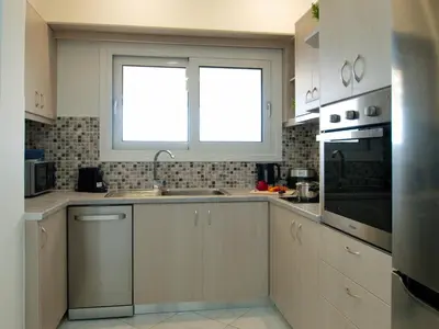 a kitchen with a sink and a window at Villa Nikos Megala Chorafia Crete in Áptera