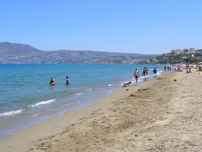a group of people playing in the water at the beach at Villa Nikos Megala Chorafia Crete in Áptera