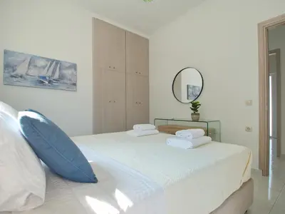 a bedroom with a bed with two pillows and a mirror at Villa Nikos Megala Chorafia Crete in Áptera