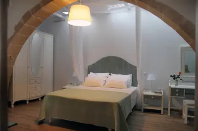 a bedroom with a bed in a room with an arch at Charming villa in Chania with parking included in Kolymvari
