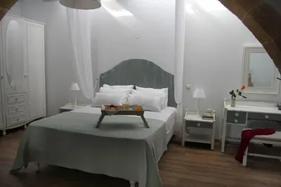 a bedroom with a bed with a table on it at Charming villa in Chania with parking included in Kolymvari