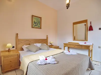 a bedroom with two beds with towels on them at Maros Spitaki in Varípetron