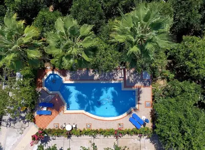an overhead view of a swimming pool with palm trees at Maros Spitaki in Varípetron