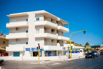 a white building on a street corner with a traffic light at Lily of Crete 2 - Sea & Beach front Apartment in Kato Galatas