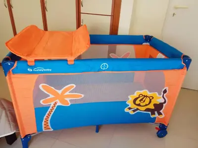 an orange and blue play cart with an orange cushion at Lily of Crete 2 - Sea & Beach front Apartment in Kato Galatas