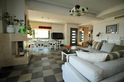 a living room with a couch and a fireplace at Amoutsa Seaside Villa in Kolymvari
