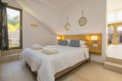 a bedroom with a large bed with towels on it at Cocoon Luxury Villas in Maleme