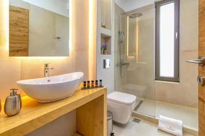 a bathroom with a sink and a toilet and a shower at Cocoon Luxury Villas in Maleme