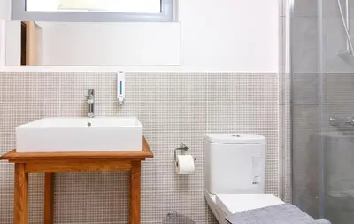 a bathroom with a sink and a toilet at Rigas City Apartment (BLUE) in Chania Town