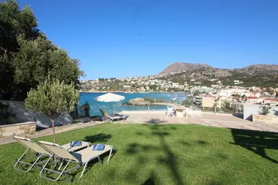 a group of chairs and a table on a grass field at Villa Sea Dream Almyrida in Almirida