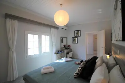 a bedroom with a bed with two towels on it at Villa Sea Dream Almyrida in Almirida