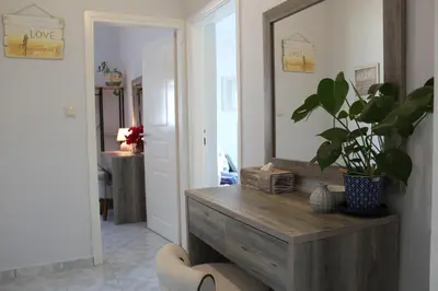 a living room with a mirror and a potted plant at Villa Sea Dream Almyrida in Almirida