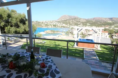 a dining table with a view of the ocean at Villa Sea Dream Almyrida in Almirida