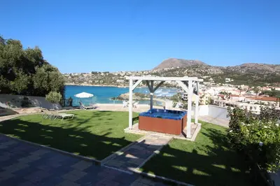 a garden with a gazebo and a view of the beach at Villa Sea Dream Almyrida in Almirida