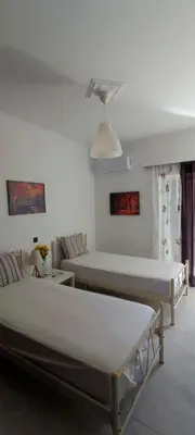 a living room with two beds and a couch at Top Holidays Apartments in Chania Town
