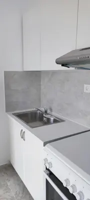 a white kitchen with a sink and a stove at Top Holidays Apartments in Chania Town