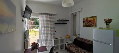 a living room with a couch and a window at Top Holidays Apartments in Chania Town