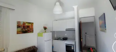 a small kitchen with a white refrigerator and a sink at Top Holidays Apartments in Chania Town