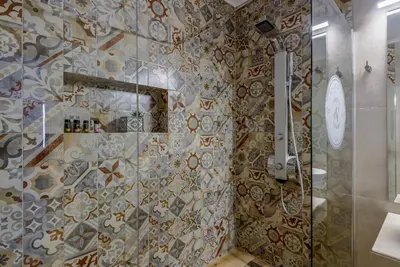 a bathroom with a shower with a glass door at Villa Vasiliki in Stalos