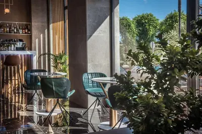 a room with chairs and tables and a window at Chania Flair Boutique Hotel, Adults only, Tapestry Collection by Hilton in Chania Town