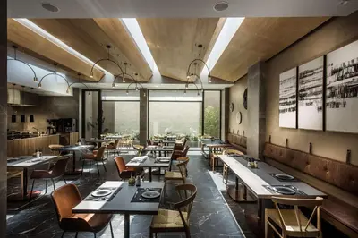 a restaurant with tables and chairs and a large window at Chania Flair Boutique Hotel, Adults only, Tapestry Collection by Hilton in Chania Town