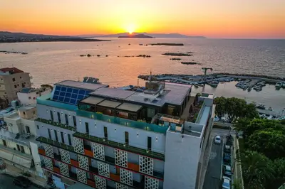 an aerial view of a building with the sunset in the background at Chania Flair Boutique Hotel, Adults only, Tapestry Collection by Hilton in Chania Town