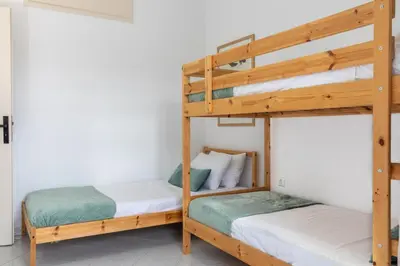 two bunk beds in a room with white walls at Villa Kelaidis in Megála Khoráfia
