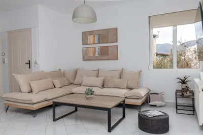a living room with a couch and a table at Villa Kelaidis in Megála Khoráfia